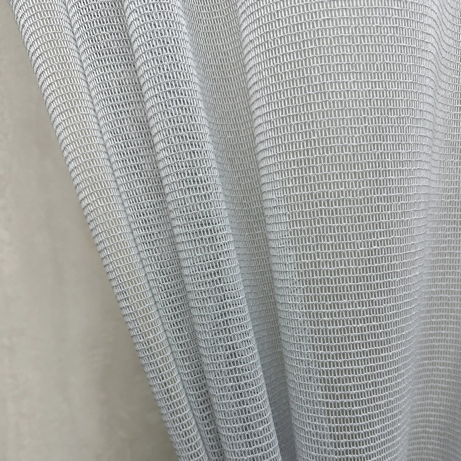 Close-up of a textured gray curtains fabric scratch proof on a neutral background