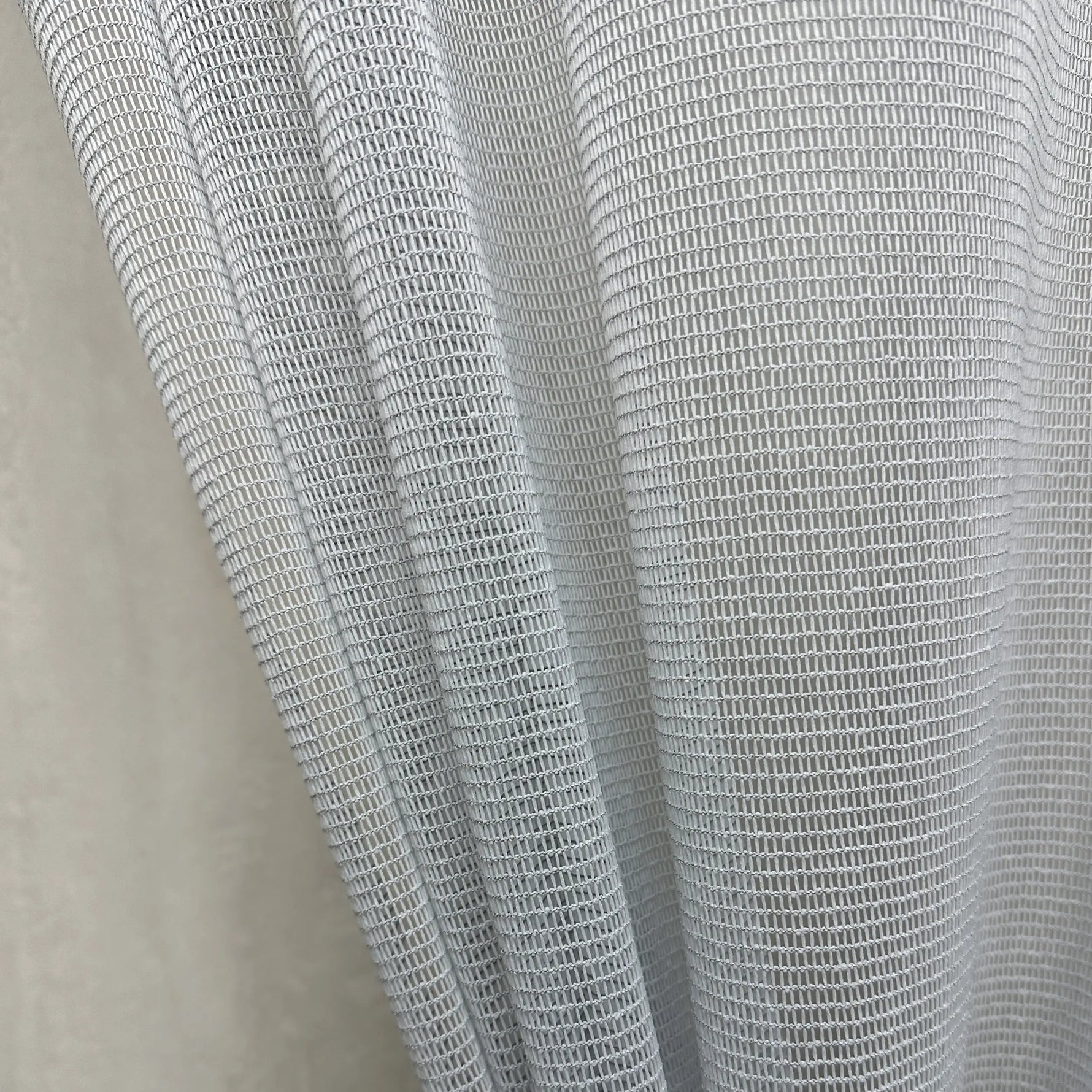 Close-up of a textured gray curtains fabric scratch proof on a neutral background