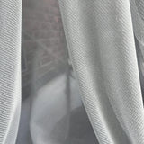 Close-up of gray fabric with a textured pattern scratch proof