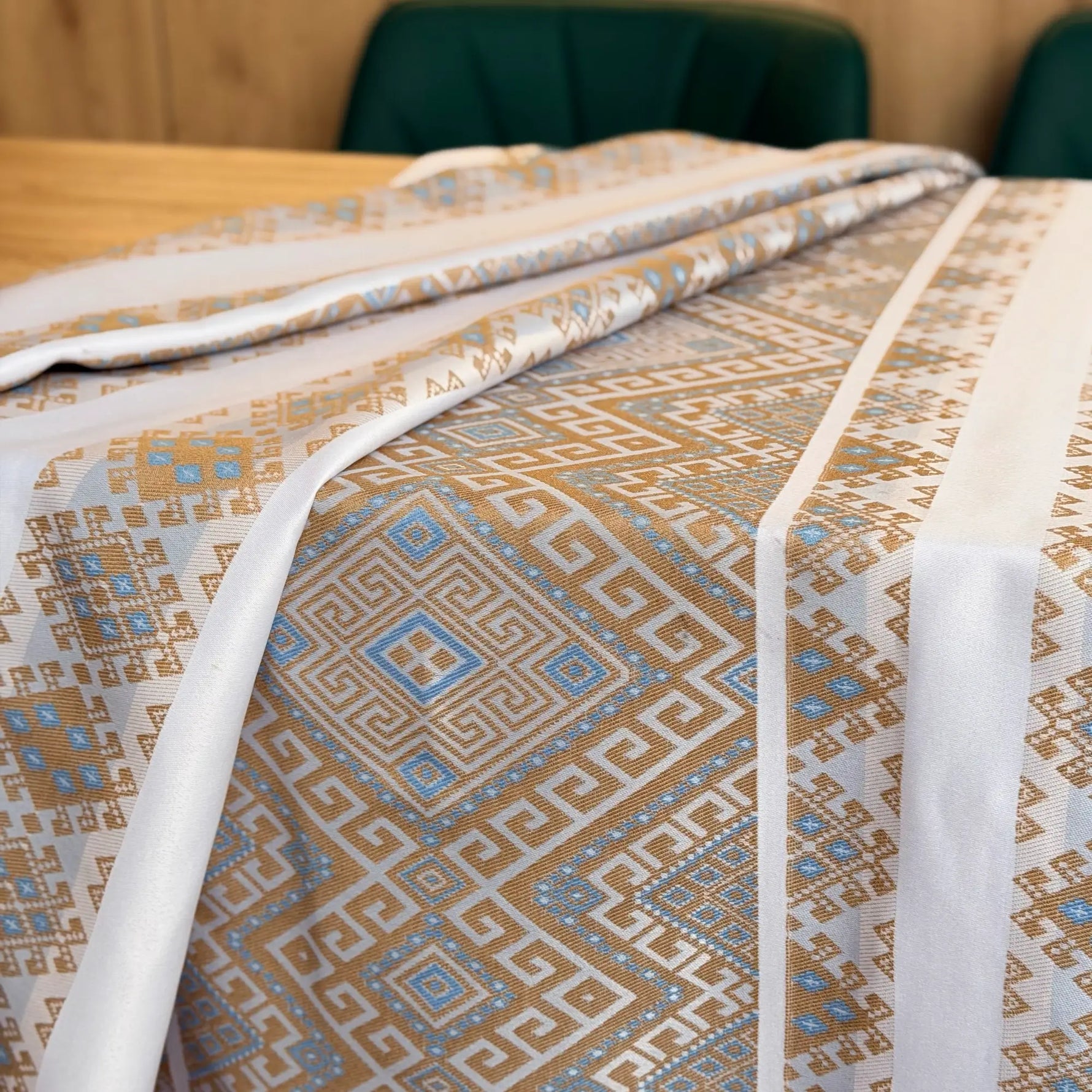 Patterned bedspread on a bed with a wooden headboard