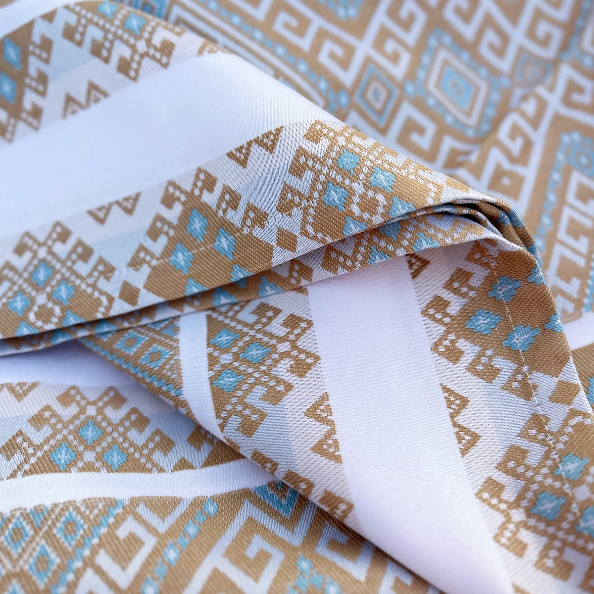 Patterned fabric with geometric design in brown, blue, and white.