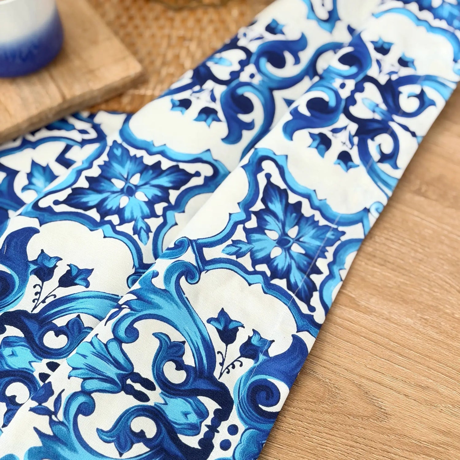 Blue and white patterned fabric on a wooden surface