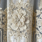 Close-up of intricate lace fabric with floral design