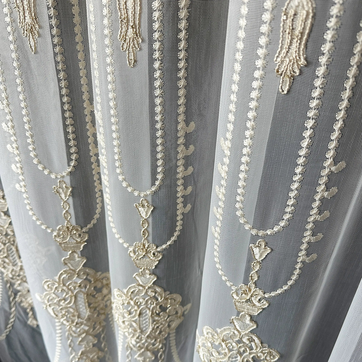 Decorative lace fabric with intricate gold embroidery 